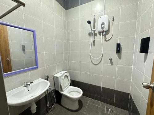 a bathroom with a shower and a toilet and a sink at La Mensa Families Cheerful Residences in Ulu Melaka