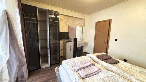 a bedroom with a bed with two pillows on it at Top of the Mountain Гранд Манастира частни Апартаменти in Pamporovo