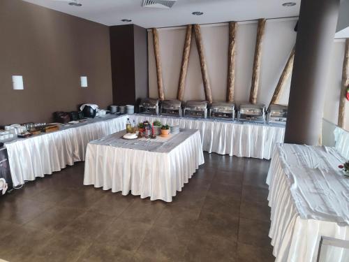 a row of tables in a room with white table cloths at Aspen Resort Studio I306 in Razlog