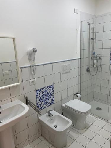 a bathroom with a sink and a toilet and a shower at casa catania termini home 3 in Catania
