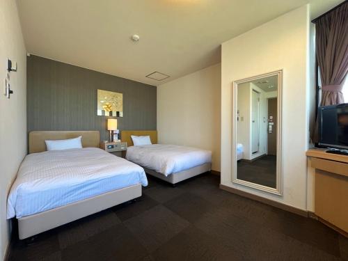 Postel nebo postele na pokoji v ubytování Hotel Route-Inn Seibu Chichibu Ekimae