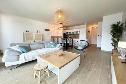 un salon avec un canapé et une table dans l'établissement T3 de standing Plein bourg - 100m des plages, à Saint-Pierre-Quiberon