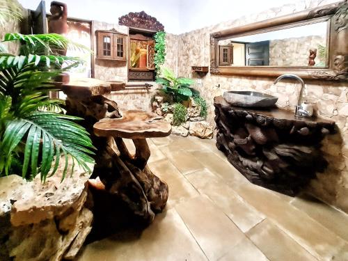a bathroom with a sink and a wooden table at Villa Paraiso - Naturism Optional Adults Only in Porches