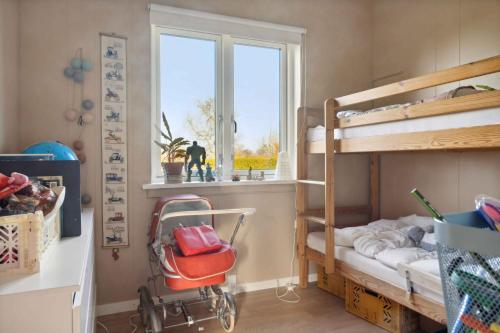 a small room with bunk beds and a window at House With A Beautiful View Of The Sea And Bogø in Stubbekøbing
