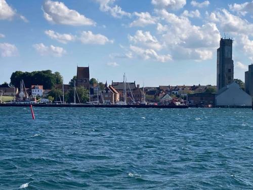 a large body of water with a city in the background at House With A Beautiful View Of The Sea And Bogø in Stubbekøbing