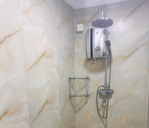 a shower with a shower head in a bathroom at Amanda Villa - Best Value Mountain top Inn in Au Cap