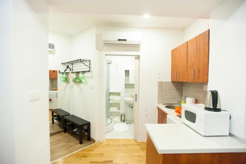 a small kitchen with a microwave on a counter at Fifty Apartments in Zagreb