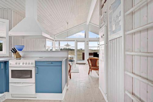 a kitchen with a blue stove top oven at Holiday House On Fanø Near The Sea in Fanø