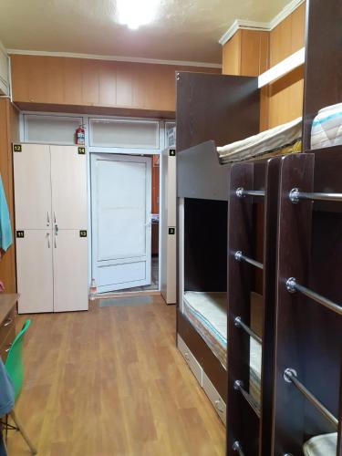 a small room with bunk beds and a closet at Хостел in Almaty
