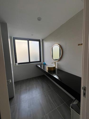 a bathroom with a mirror and a sink at Liverpool House Mộc Châu in Mộc Châu