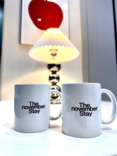 two coffee mugs with the november show on them at The November Stay Guri Station in Guri