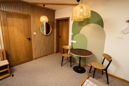a room with a table and two chairs and a door at Zajazd w Biskupinie in Biskupin