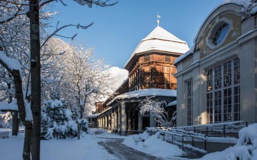 a building covered in snow in front at Galerie Hotel in Bad Reichenhall