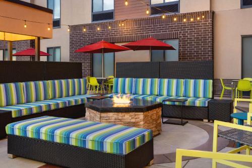 a patio with couches and a table and chairs at Home2 Suites by Hilton Denver West / Federal Center in Lakewood