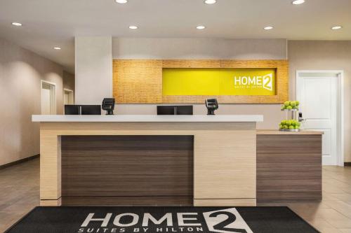 a lobby with a home sign on the wall at Home2 Suites by Hilton Denver West / Federal Center in Lakewood