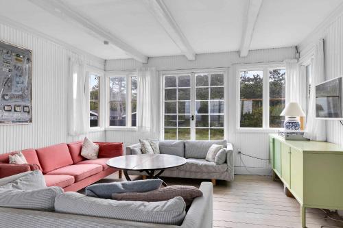 a living room with a couch and a table at Welcoming Holiday Home Right Down To The Water in Rørvig
