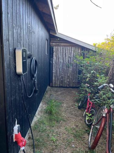 a house with a hose hooked up to a wall at Welcoming Holiday Home Right Down To The Water in Rørvig