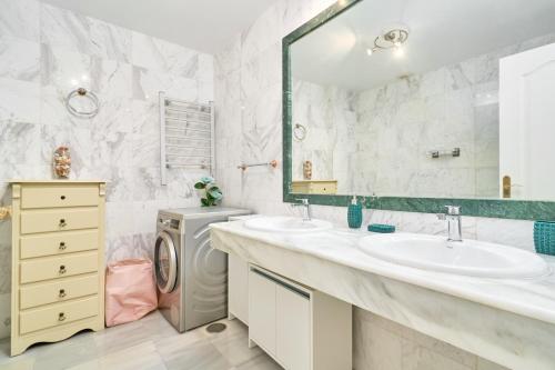 ein Badezimmer mit 2 Waschbecken und einer Waschmaschine in der Unterkunft Vista al Mar in La Herradura
