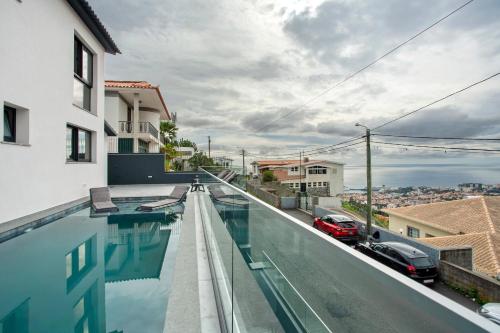 a swimming pool on the roof of a building at Villa Angela in Funchal