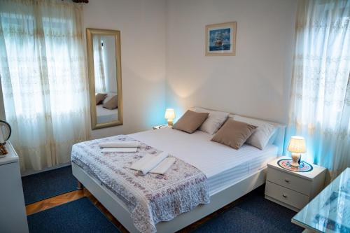 a bedroom with a large bed with a mirror at Guest House Cesic in Dubrovnik