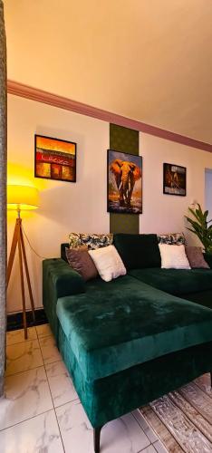 a living room with a green couch in a room at Kian Nest in Mombasa