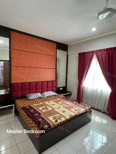 a bedroom with a large bed with a red headboard at Daily Homey homestay in Kota Kinabalu