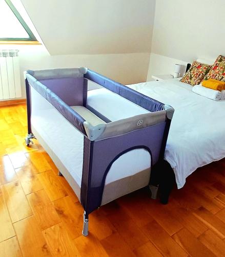a blue and white bed in a room at Casa Mila Zlatibor in Zlatibor