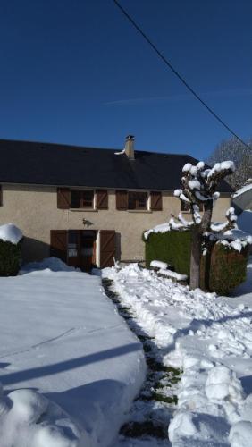 a house with a snow covered driveway in front of it at Gîte de la Séoube in Campan