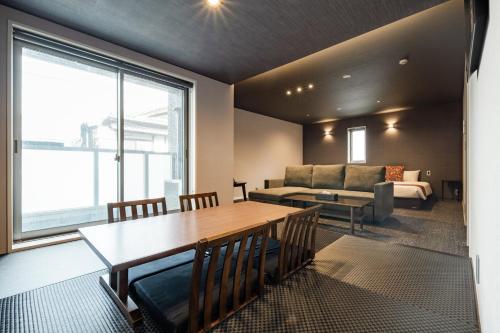 a living room with a table and a couch at GRAND BASE Moji Nagomi in Kitakyushu