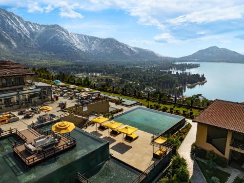 an aerial view of a resort with a lake and mountains at Taj Dal View Srinagar in Srinagar