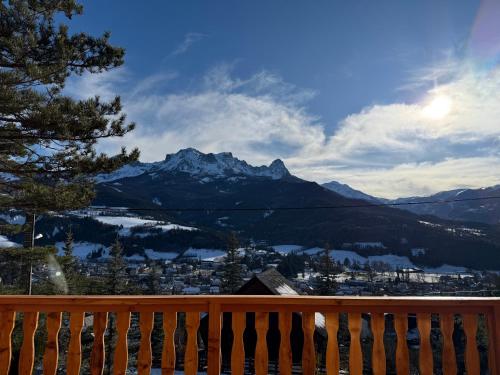 a view of the mountains from a wooden bench at Chalet avec Spa Magnifique vue in Barcelonnette