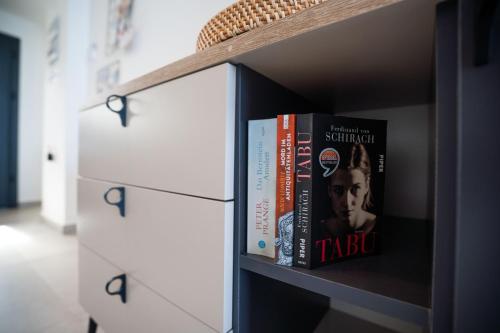 two books on a shelf in a bookcase at Oceanfront Oasis with Private Pool Stunning Views in Kérynia