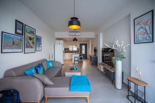 a living room with a couch and a table at Oceanfront Oasis with Private Pool Stunning Views in Kérynia