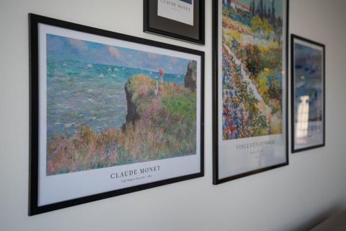 a group of framed pictures hanging on a wall at Oceanfront Oasis with Private Pool Stunning Views in Kérynia