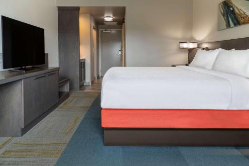 a hotel room with a bed and a flat screen tv at Hilton Garden Inn Fredericton in Fredericton