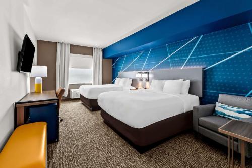 a hotel room with two beds and a couch at Comfort Inn & Suites Donna near I-2 in Donna