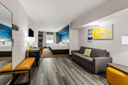 a living room with a couch and a bedroom at Comfort Inn & Suites Donna near I-2 in Donna