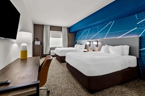 a hotel room with two beds and a desk at Comfort Inn & Suites Donna near I-2 in Donna