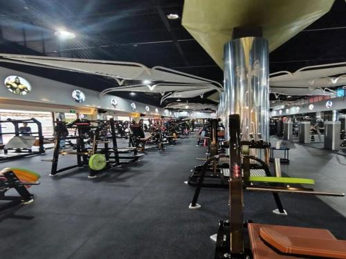 a gym with a bunch of treadmills and machines at Annie 2704-only 260 metres from Metro Line 2 Exit C of BeiChun in Kunming