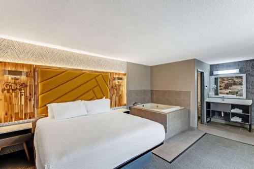 a bedroom with a bed and a bath tub at The Wander Hotel in Gatlinburg