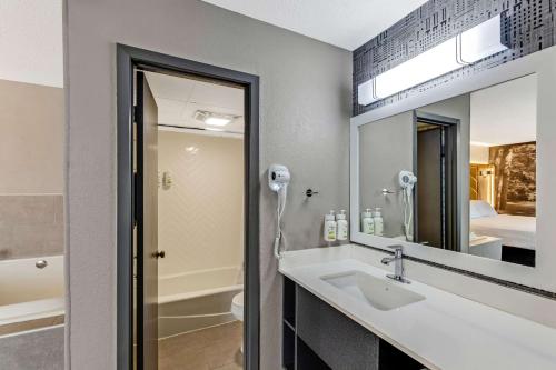a bathroom with a sink and a mirror at The Wander Hotel in Gatlinburg