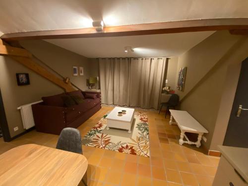 a living room with a couch and a table at L'Air du Pré - loft 5p - Mariomont in Verviers