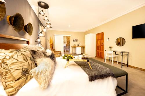 a living room with a couch and a table at Zabini Lodge and Game Drives in Nelspruit