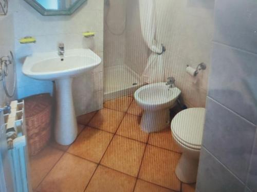a bathroom with a sink and a toilet at two-room apartment with parking space in Rio nellʼElba