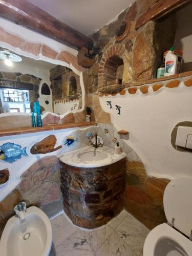 a bathroom with a sink and a tub with a toilet at Appartamento Bluette in Rio nellʼElba