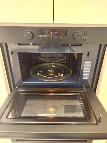 an oven with its door open in a kitchen at Majestic Seoul Stay Central in Seoul