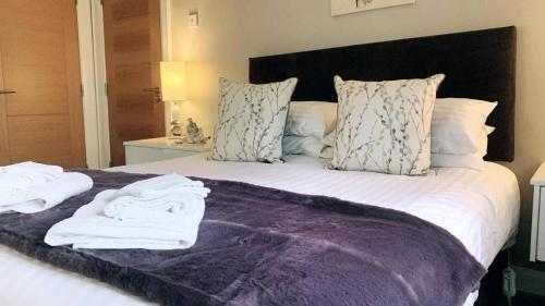 a bedroom with a bed with towels on it at Warrenpoint Countryside House-3bedroom- Private Garden in Newry