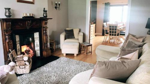 a living room with a couch and a fireplace at Warrenpoint Countryside House-3bedroom- Private Garden in Newry