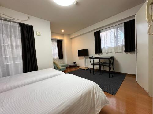 Postel nebo postele na pokoji v ubytování Kamata Opus2 Apartment