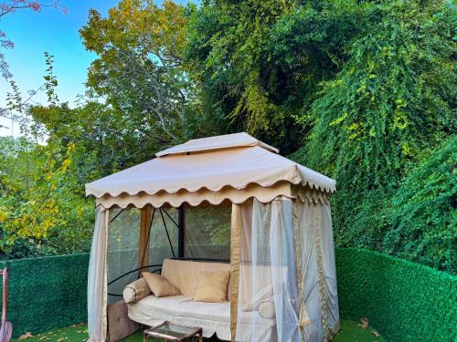 a couch in a gazebo in a yard at The Old Mill Hotel Lapta in Kérynia